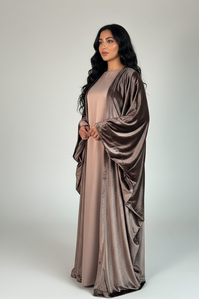 Woman wearing a long, flowing dress with a matching shawl on a white background