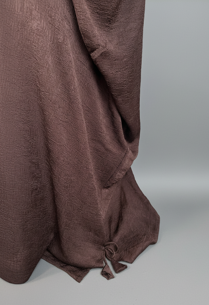 Brown fabric draped over a gray background